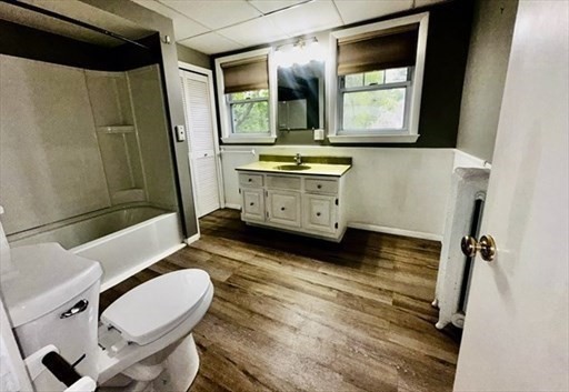 59 14th Avenue, Unit 2 Haverhill, MA 01830 - Photo 9 of 11 a bathroom with a sink a toilet and mirror