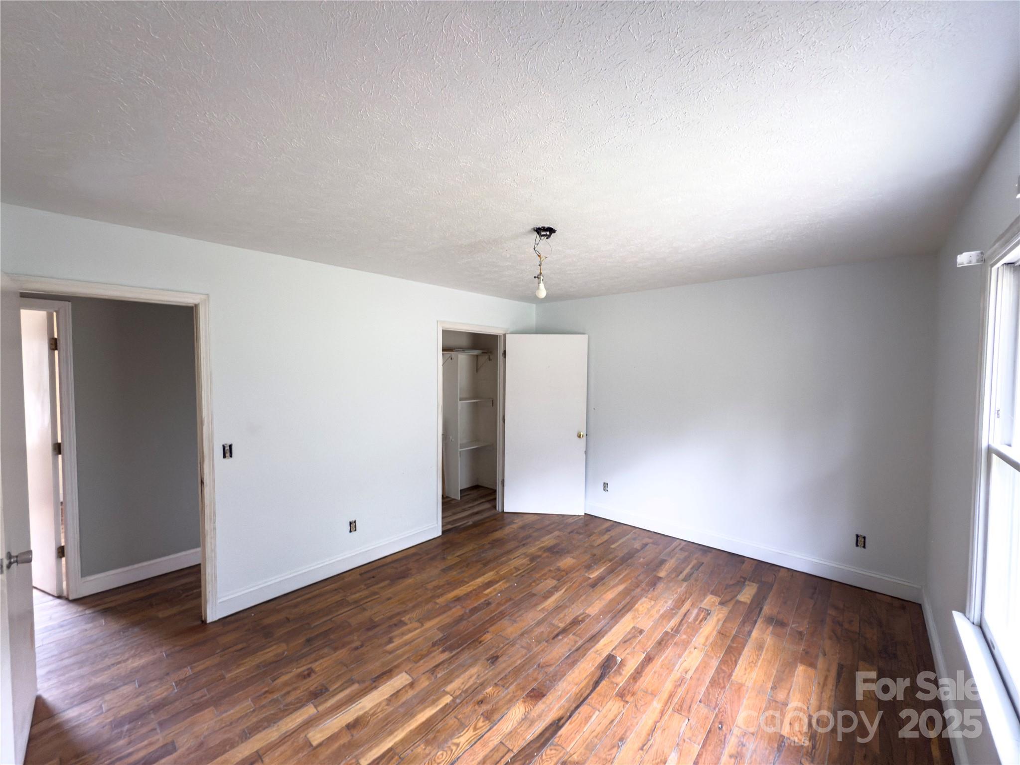 931 Emerald Place Southwest Lenoir, NC 28645 - Photo 4 of 10 an empty room with wooden floor and windows