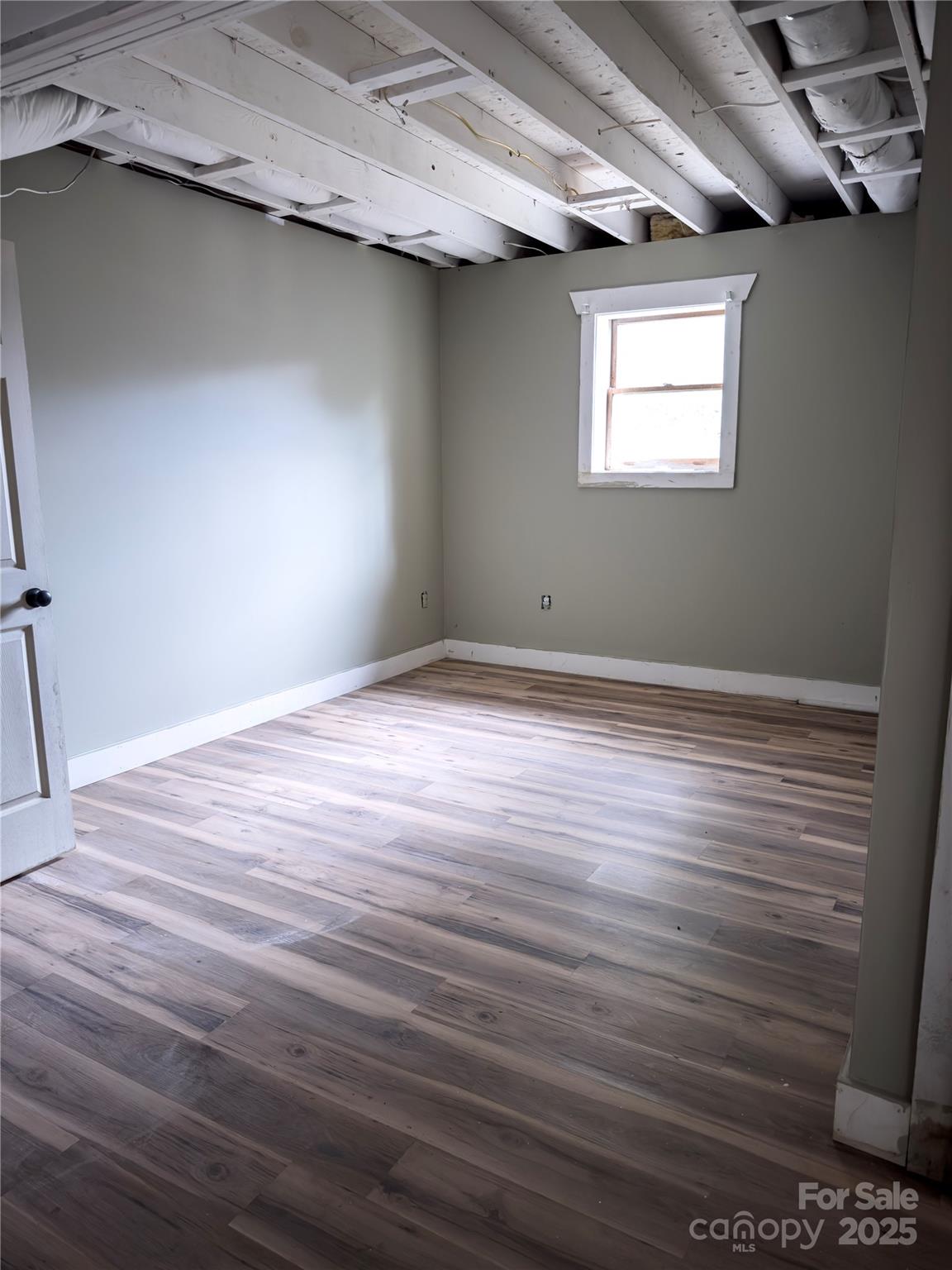 931 Emerald Place Southwest Lenoir, NC 28645 - Photo 9 of 10 a view of an empty room with wooden floor and a window