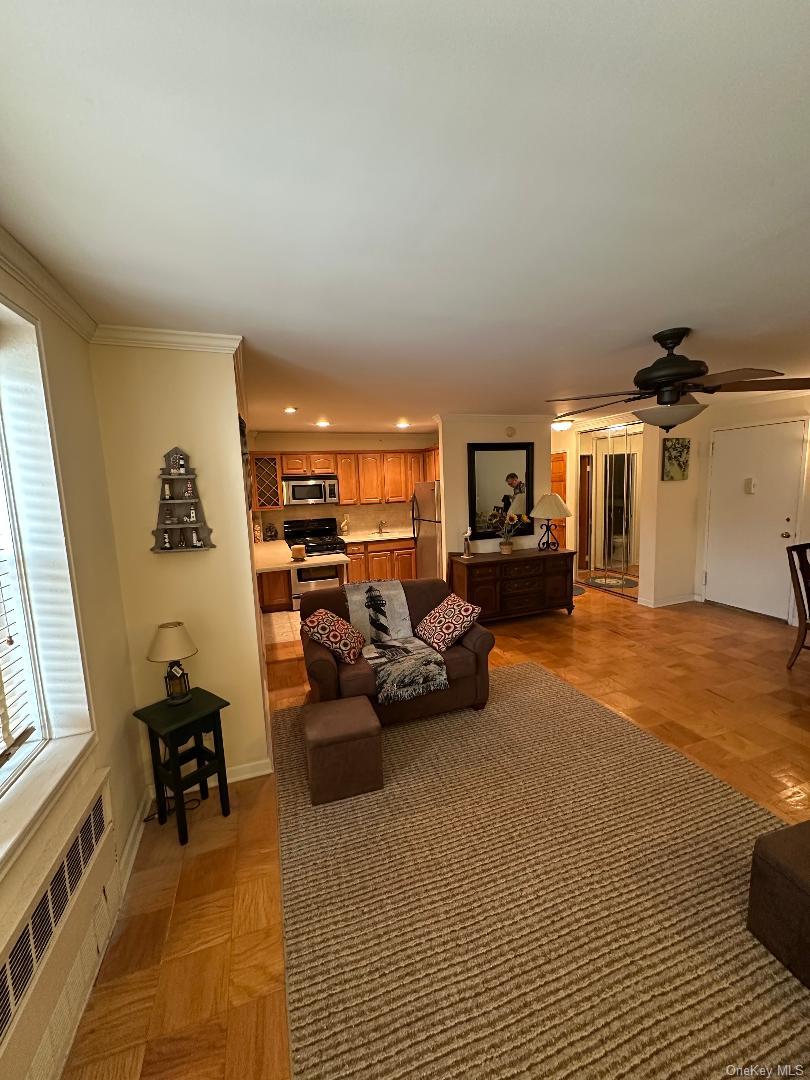 770 Shore Road, Unit 6EE Long Beach, NY 11561 - Photo 5 of 13 Living room with radiator heating unit, a ceiling fan, and recessed lighting