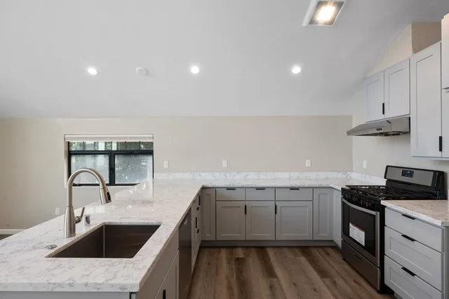 a kitchen that has a sink and a stove