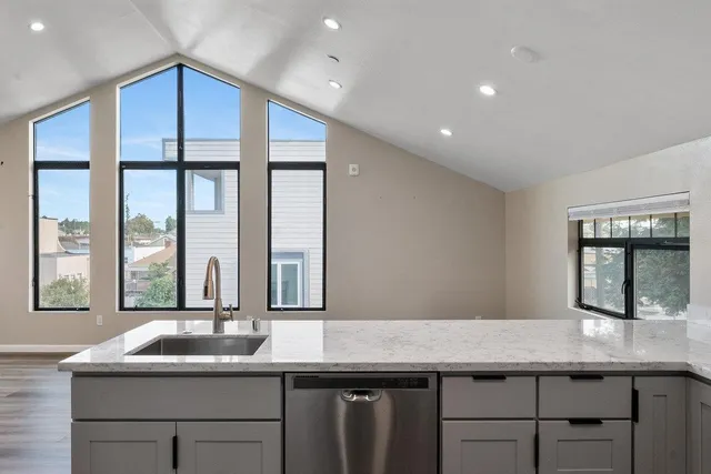 a kitchen with granite countertop a sink and a window