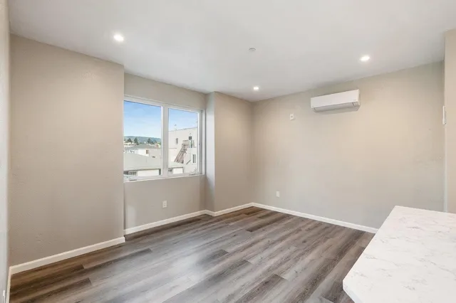a view of wooden floor and windows in a room