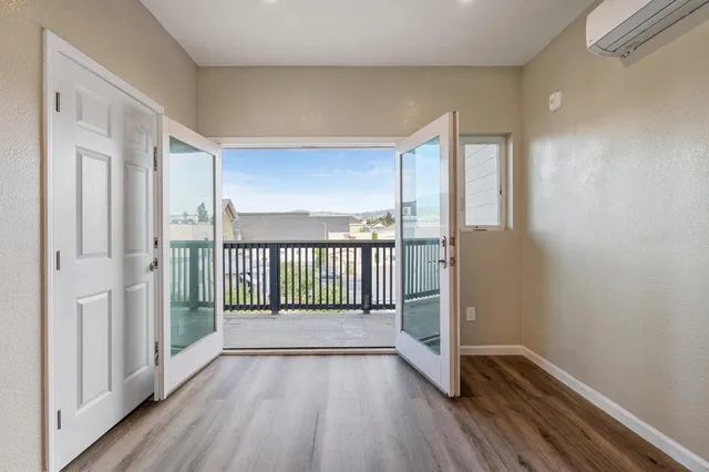 a view of a room with wooden floor and windows