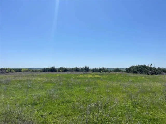 a view of an ocean beach and a yard