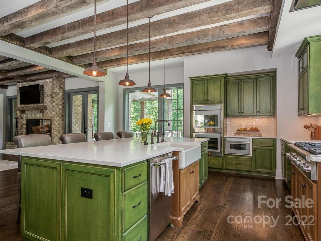 13601 Girl Scout Road Charlotte, NC 28278 - Photo 12 of 45 a kitchen with kitchen island a sink stove and cabinets
