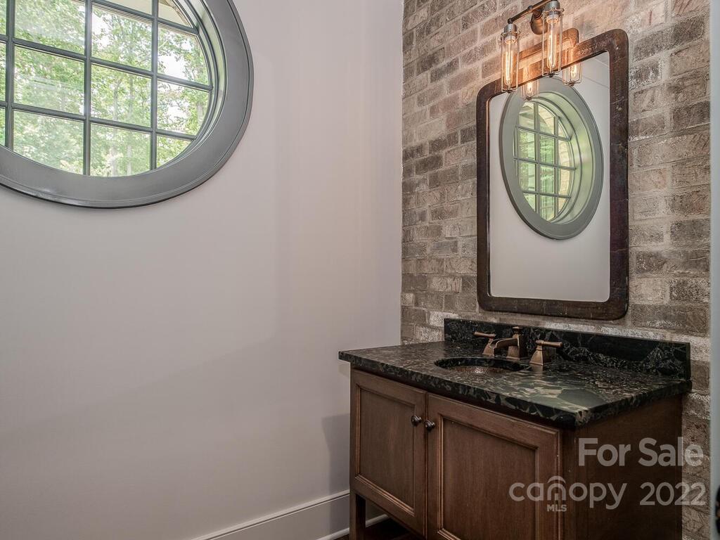 13601 Girl Scout Road Charlotte, NC 28278 - Photo 19 of 45 a bathroom with a sink and a mirror