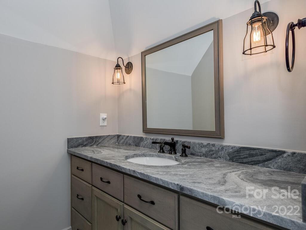13601 Girl Scout Road Charlotte, NC 28278 - Photo 23 of 45 a bathroom with a granite countertop sink and a mirror