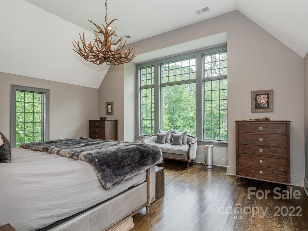 13601 Girl Scout Road Charlotte, NC 28278 - Photo 24 of 45 a bedroom with a bed dresser and wooden floor