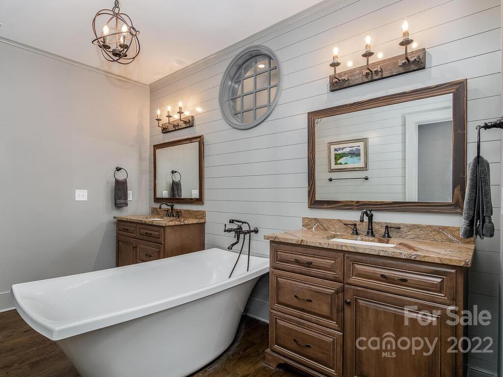 13601 Girl Scout Road Charlotte, NC 28278 - Photo 26 of 45 a bathroom with a bathtub and a mirror