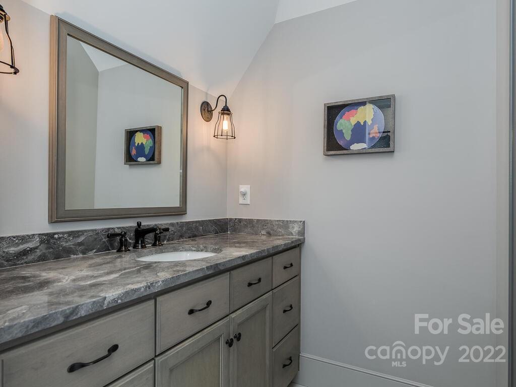 13601 Girl Scout Road Charlotte, NC 28278 - Photo 31 of 45 a bathroom with a granite countertop sink and a mirror
