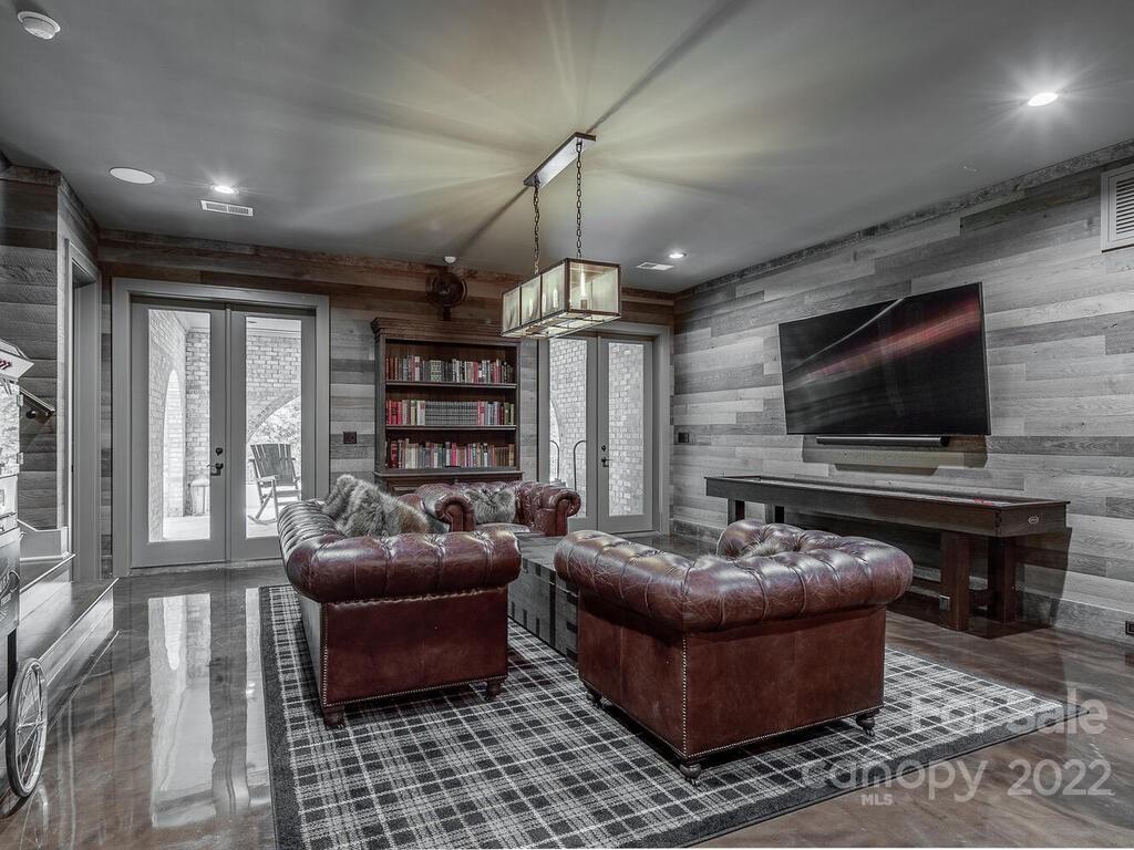 13601 Girl Scout Road Charlotte, NC 28278 - Photo 35 of 45 a living room with furniture a flat screen tv and a fireplace