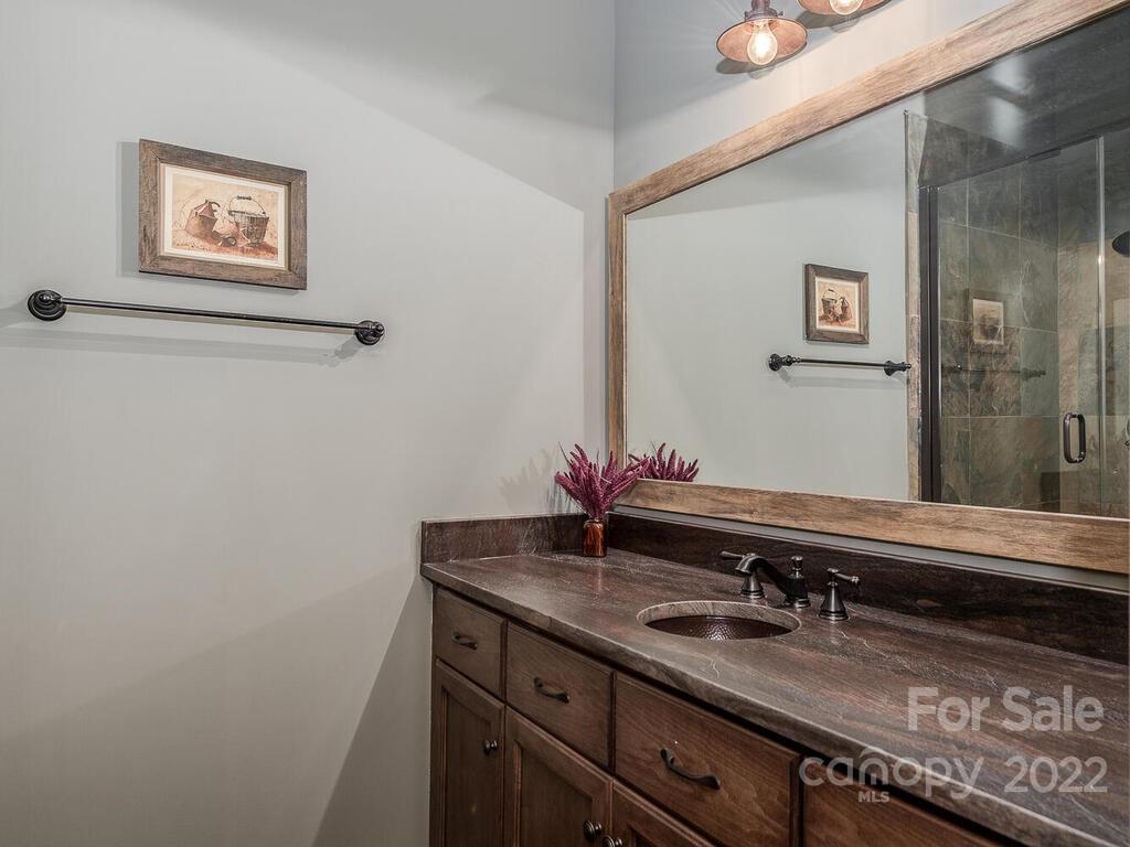 13601 Girl Scout Road Charlotte, NC 28278 - Photo 36 of 45 a bathroom with a granite countertop sink a mirror and a