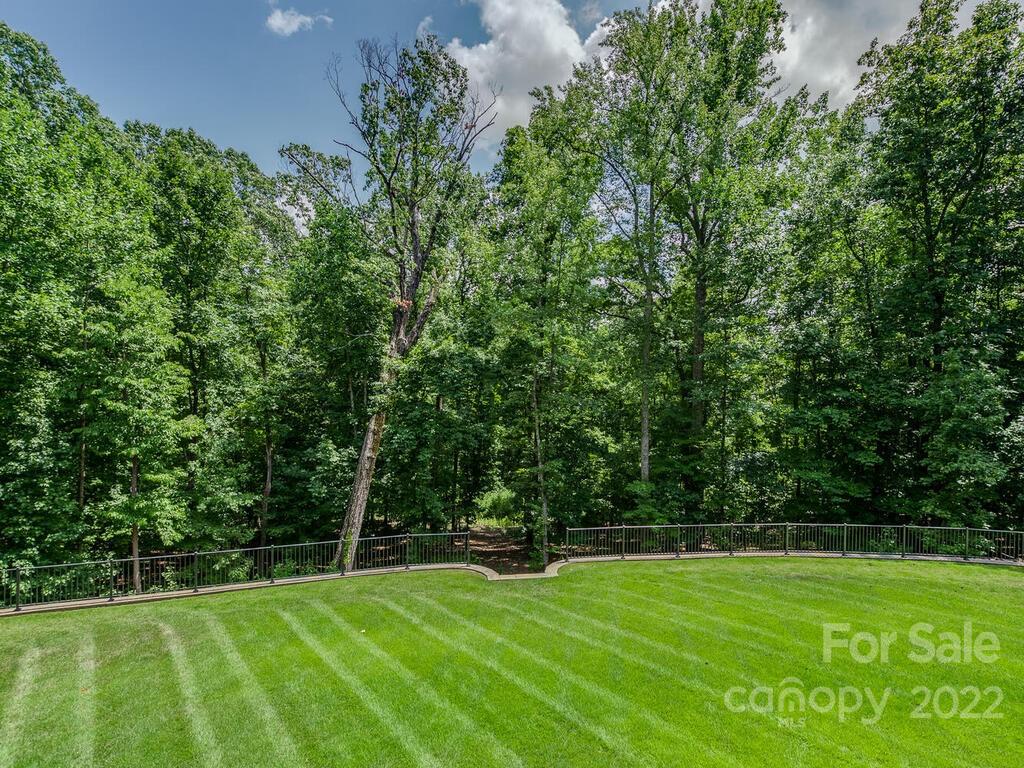 13601 Girl Scout Road Charlotte, NC 28278 - Photo 39 of 45 a view of a tennis ground with large trees