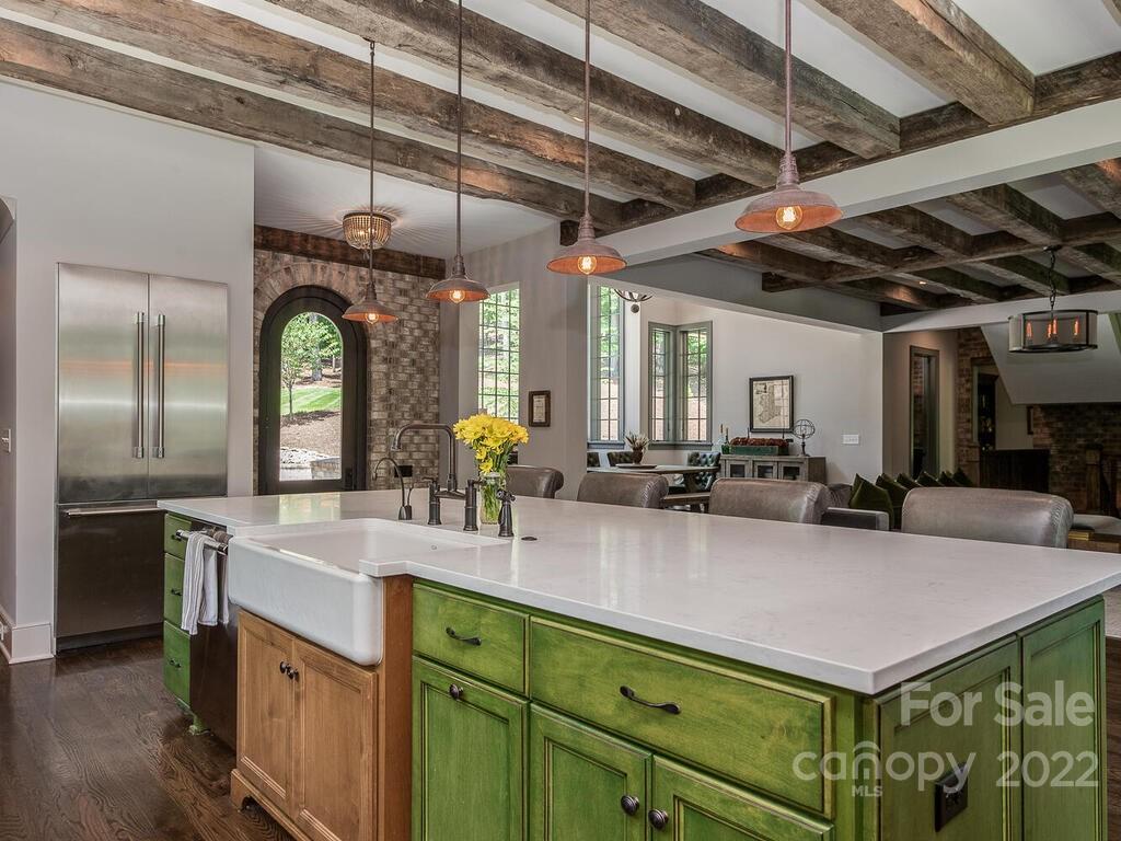 13601 Girl Scout Road Charlotte, NC 28278 - Photo 9 of 45 a kitchen with kitchen island granite countertop a sink a counter space appliances and cabinets