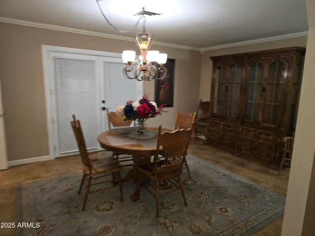 a view of a dining room with furniture and chandelier