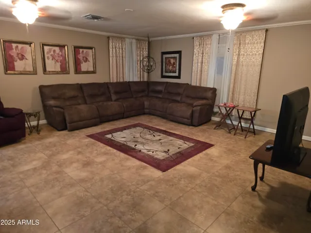 a living room with furniture rug and window