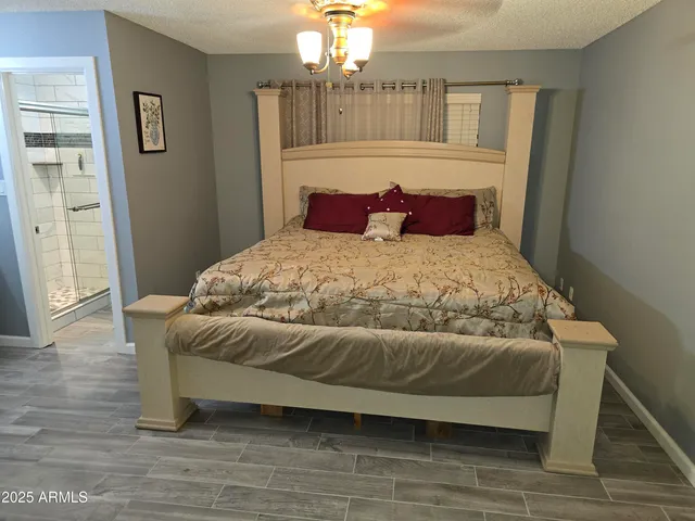 a bedroom with a bed and a chandelier