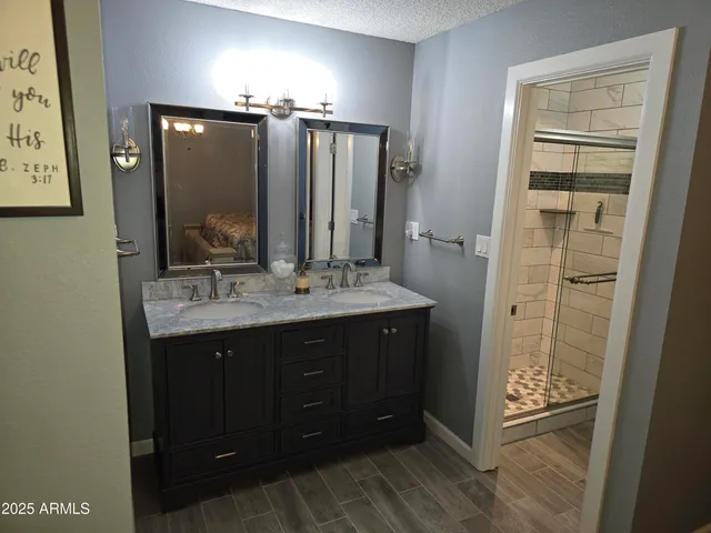 a bathroom with a sink vanity and mirror