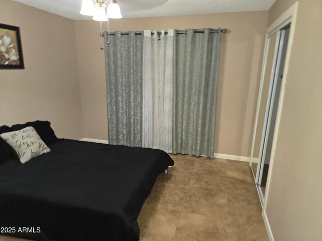 a bed sitting in a bedroom next to a window