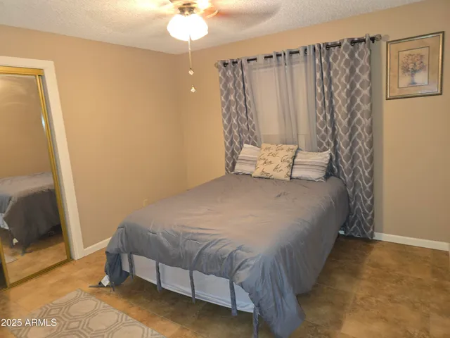 a bedroom with a bed and a mirror