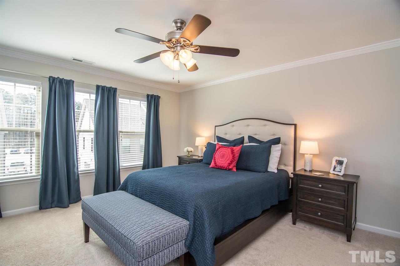 1240 Exchange Place Durham, NC 27713 - Photo 13 of 30 a bedroom with a large bed and a chandelier