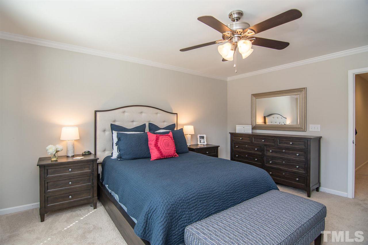 1240 Exchange Place Durham, NC 27713 - Photo 14 of 30 a bedroom with a bed and a chandelier