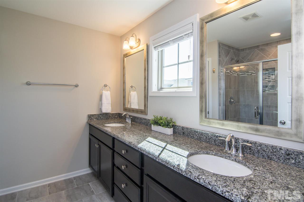 1240 Exchange Place Durham, NC 27713 - Photo 15 of 30 a bathroom with a granite countertop sink and a mirror