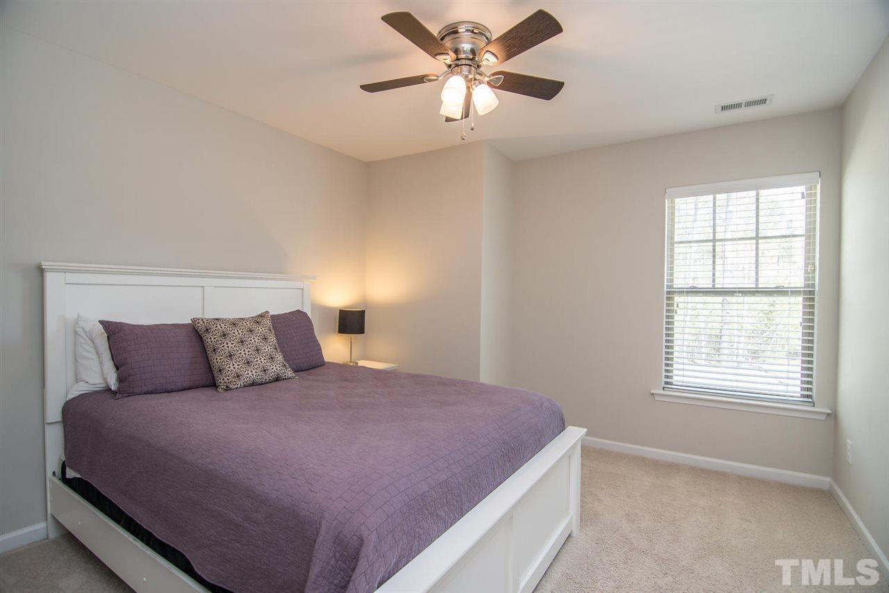 1240 Exchange Place Durham, NC 27713 - Photo 17 of 30 a bedroom with a large bed and two windows