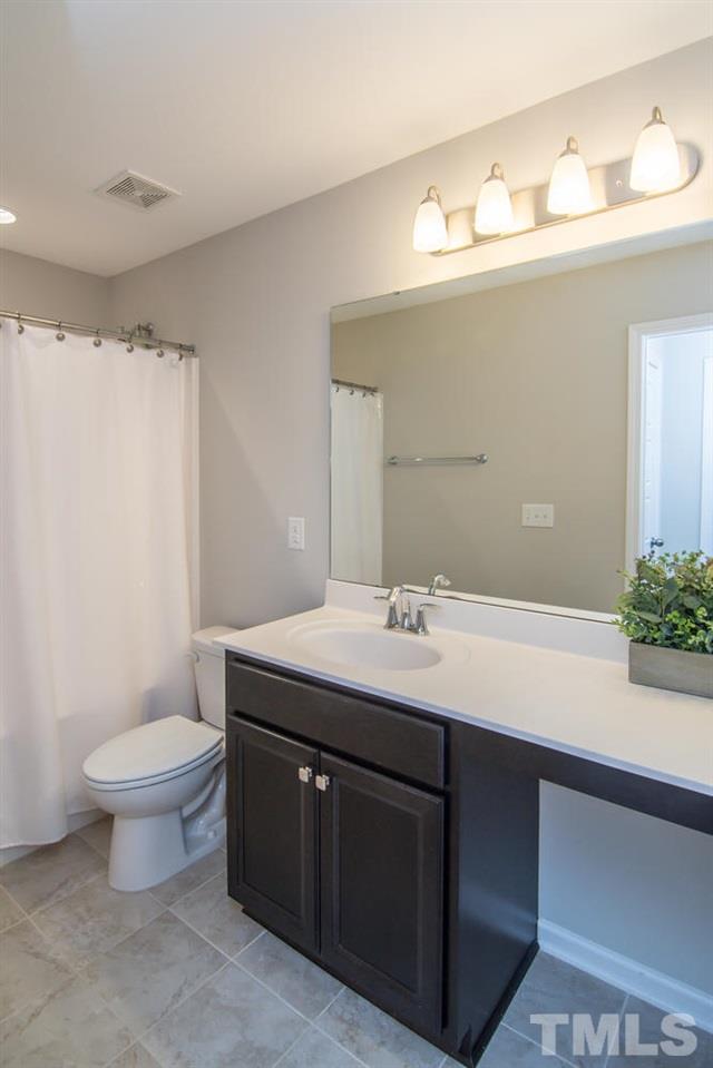 1240 Exchange Place Durham, NC 27713 - Photo 20 of 30 a bathroom with a sink toilet and a mirror