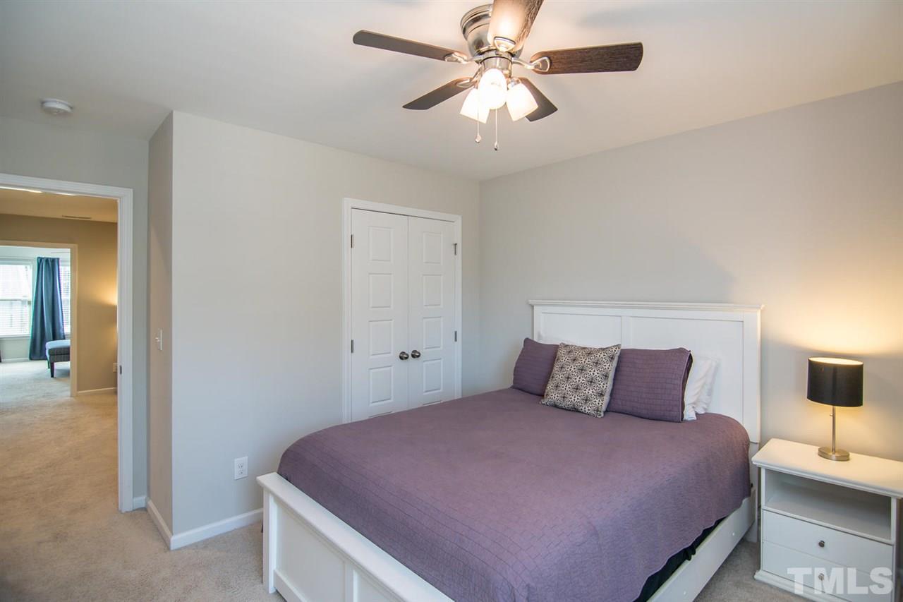 1240 Exchange Place Durham, NC 27713 - Photo 21 of 30 a bedroom with a bed and a painting on the wall
