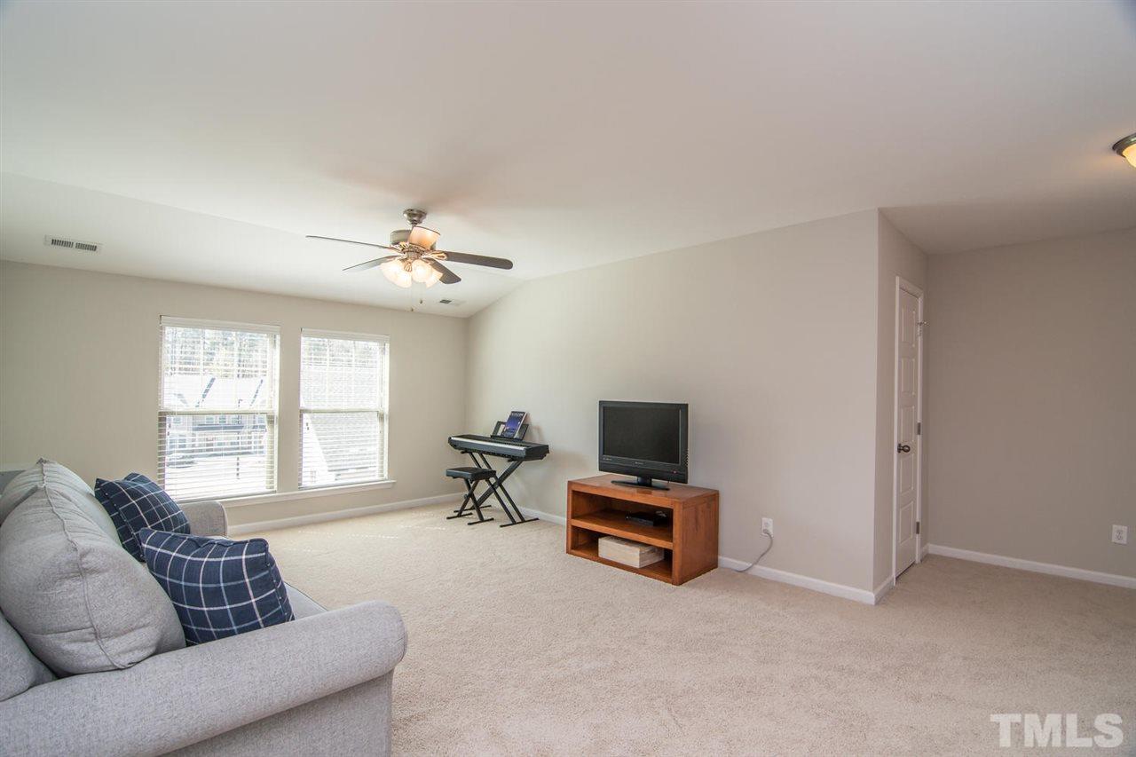 1240 Exchange Place Durham, NC 27713 - Photo 23 of 30 a living room with furniture and a flat screen tv