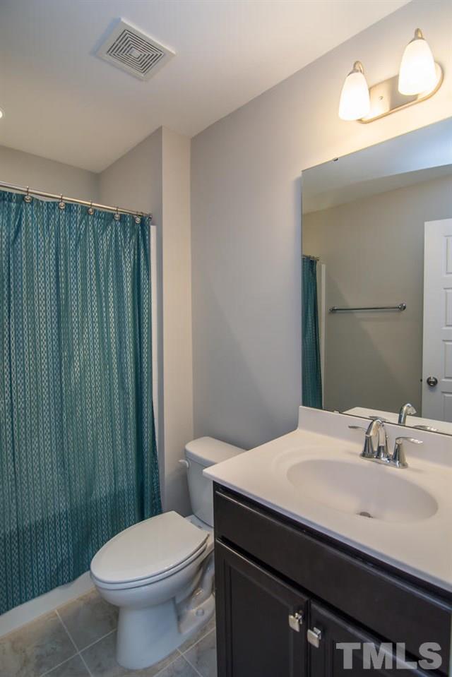 1240 Exchange Place Durham, NC 27713 - Photo 24 of 30 a bathroom with a sink a toilet and shower