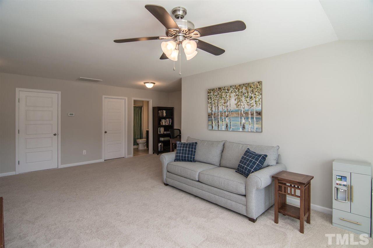 1240 Exchange Place Durham, NC 27713 - Photo 25 of 30 a living room with furniture and a ceiling fan