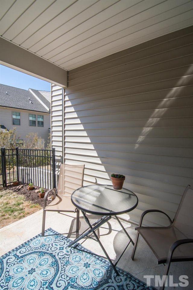 1240 Exchange Place Durham, NC 27713 - Photo 26 of 30 a balcony with chairs and wooden floor