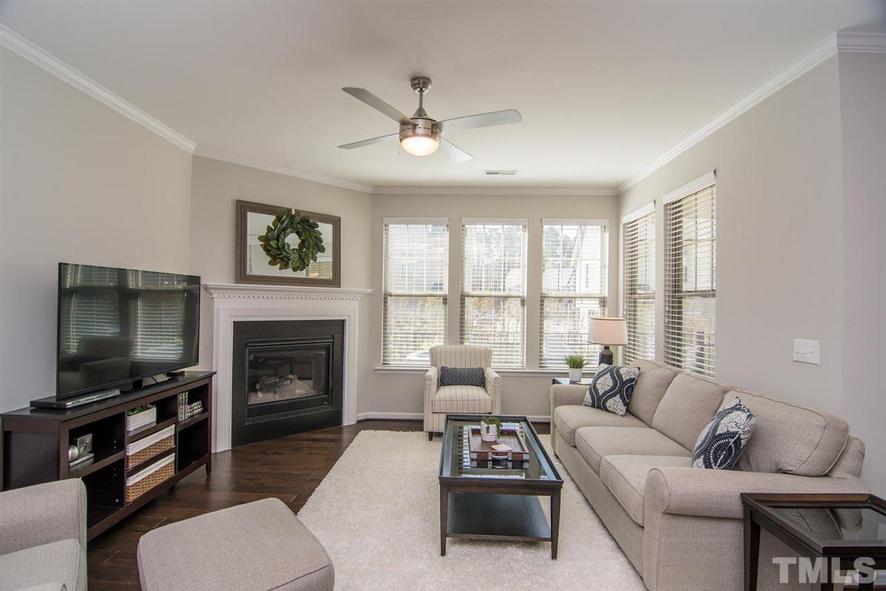 1240 Exchange Place Durham, NC 27713 - Photo 4 of 30 a living room with furniture a flat screen tv and a fireplace