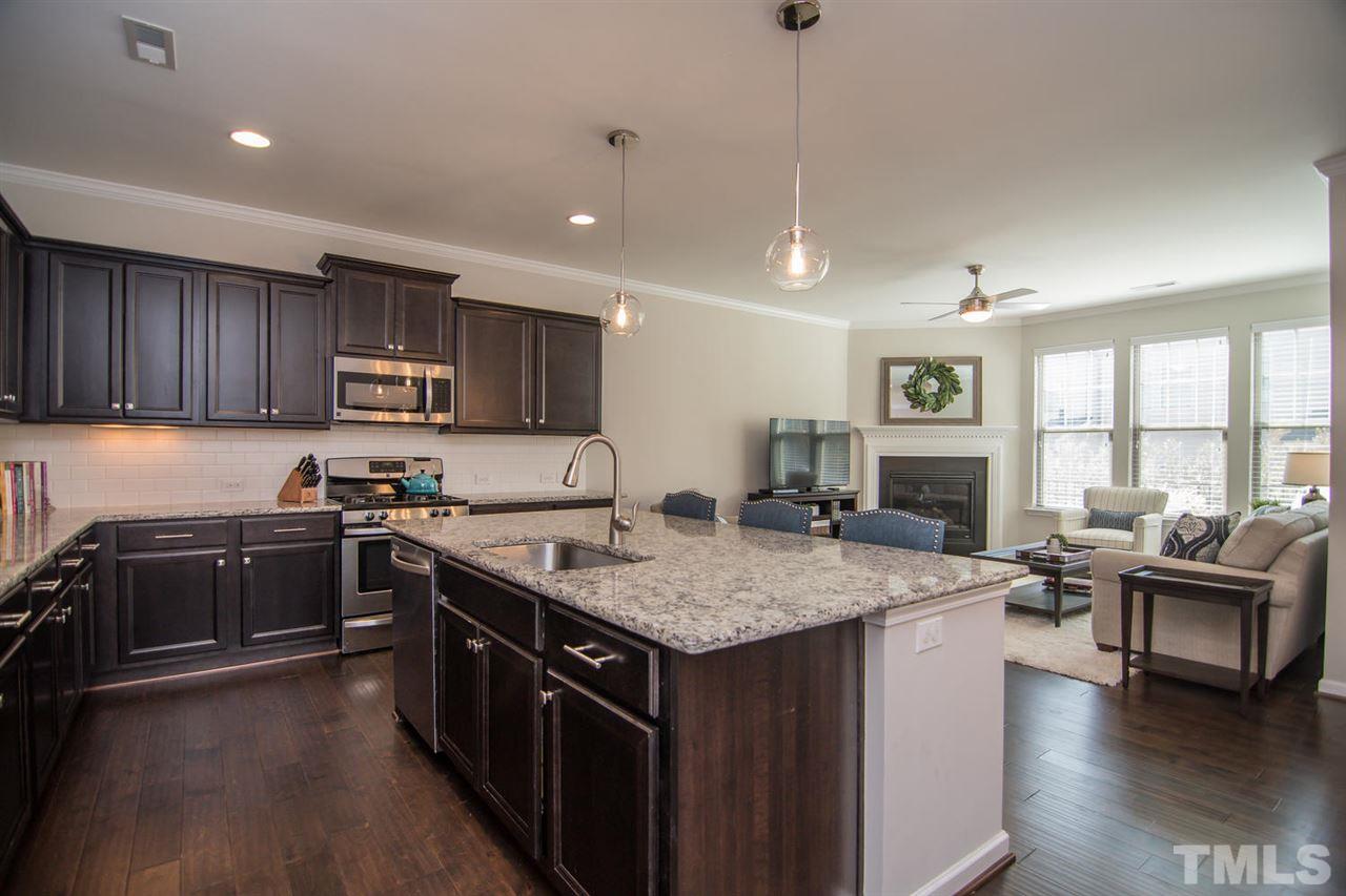 1240 Exchange Place Durham, NC 27713 - Photo 7 of 30 a kitchen with a stove sink and cabinets