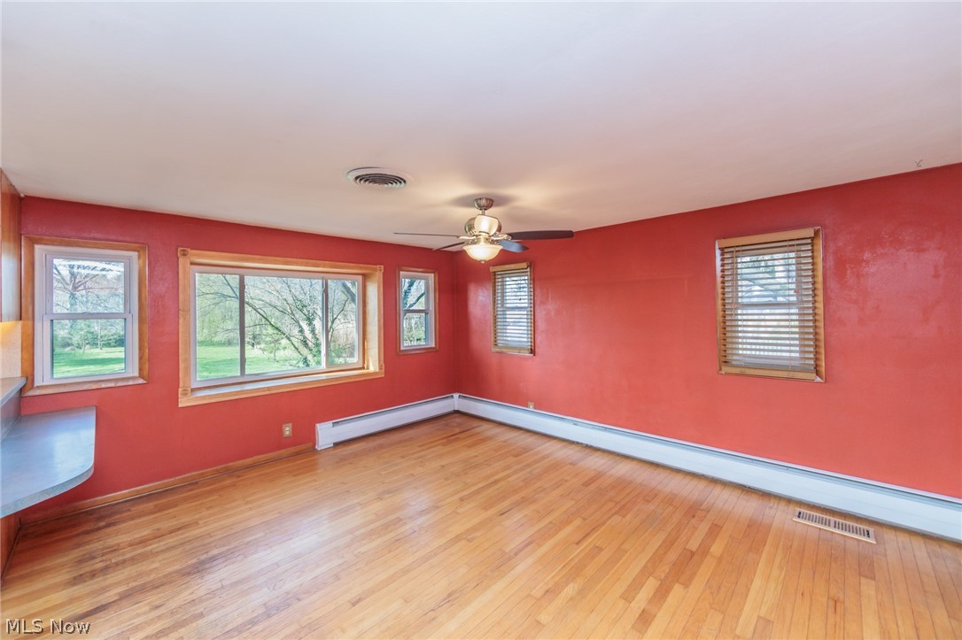 38565 Sugar Ridge Road North Ridgeville, OH 44039 - Photo 12 of 49 Unfurnished room with ceiling fan, light hardwood / wood-style floors, and baseboard heating