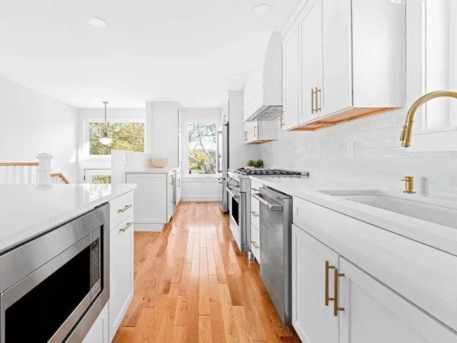 a kitchen with a sink stove and cabinets