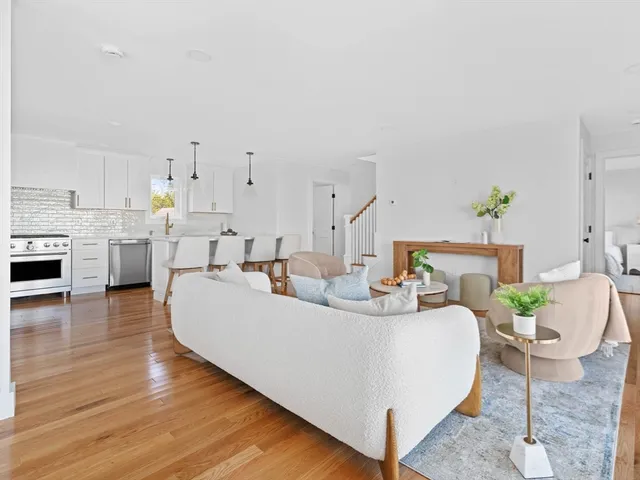 a living room with furniture and kitchen view
