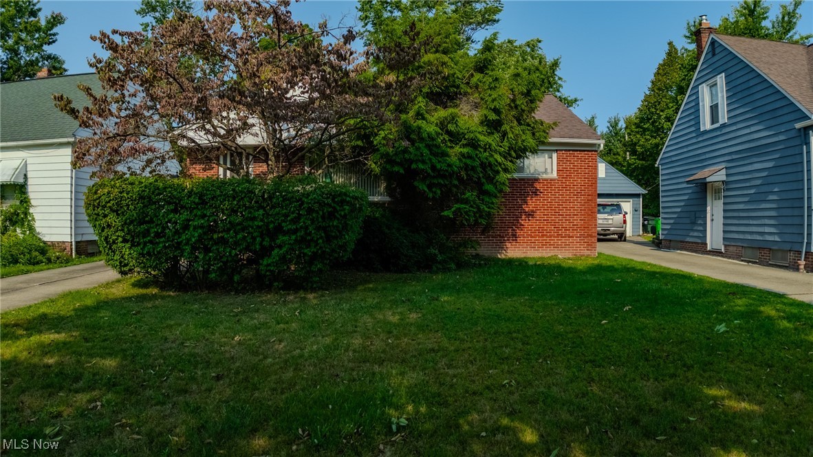 920 Clinton Avenue Cleveland, OH 44121 - Photo 1 of 14 View of yard featuring a garage