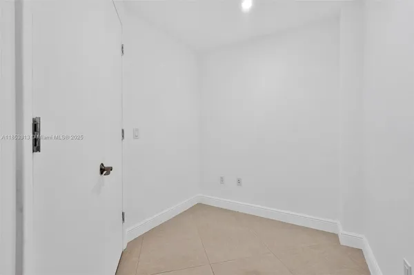 an empty room with glass door and glass door