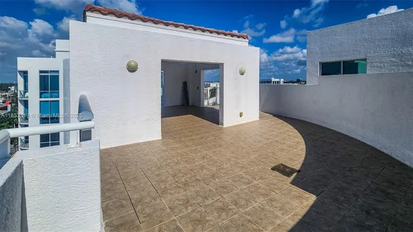 a living room with furniture and large windows