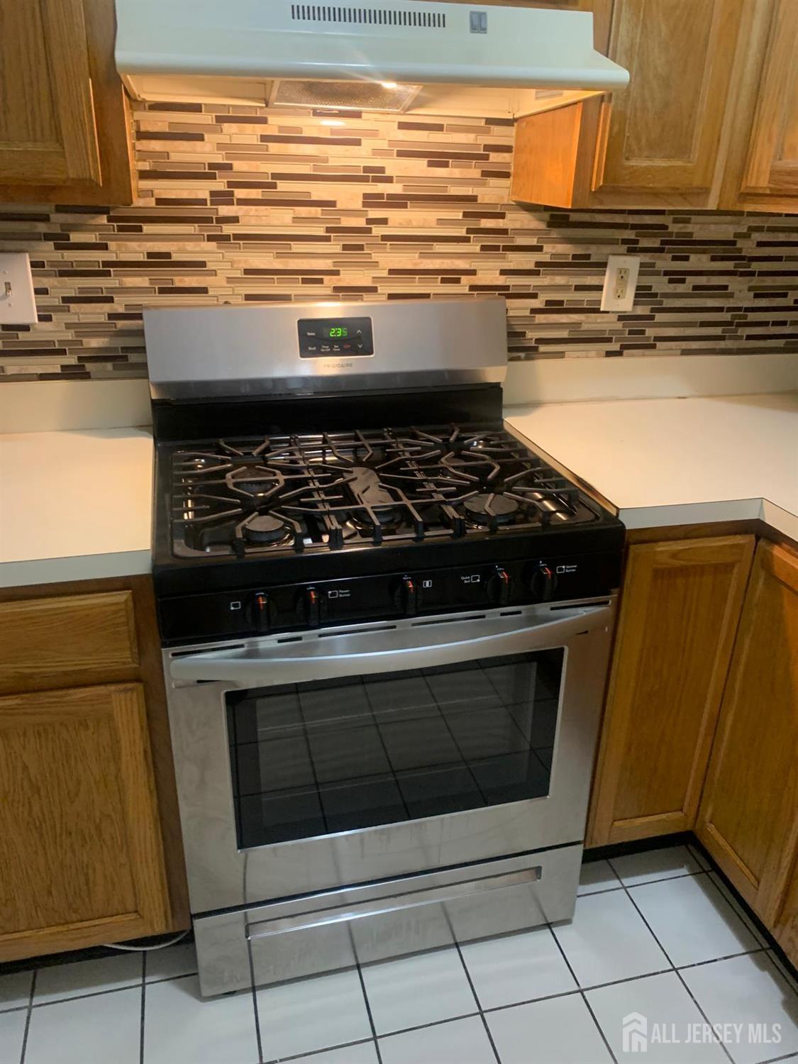 132 Remsen Avenue New Brunswick, NJ 08901 - Photo 7 of 11 a stove top oven sitting inside of a kitchen