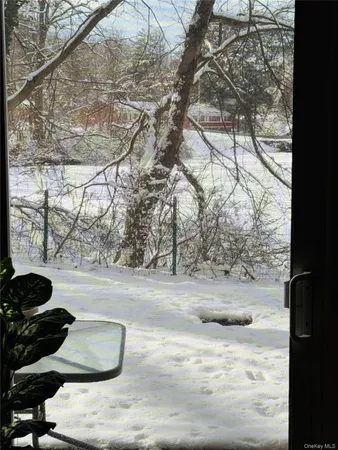 a kitchen with stainless steel appliances kitchen island granite countertop a table chairs and a refrigerator