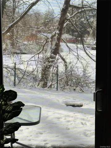 a kitchen with stainless steel appliances kitchen island granite countertop a table chairs and a refrigerator