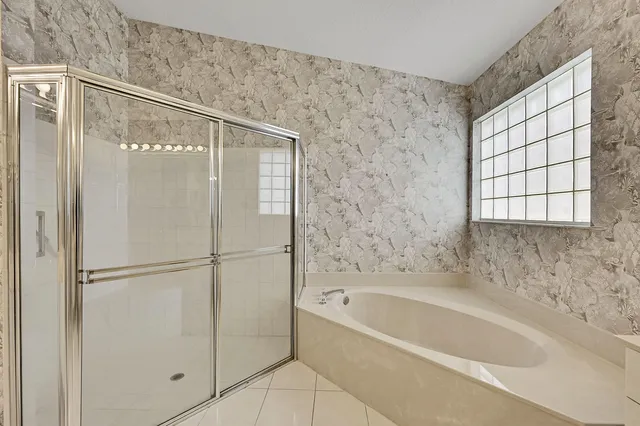 a bathroom with a double vanity sink mirror and shower