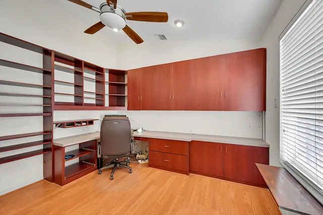 a kitchen with stainless steel appliances kitchen island wooden floors and view living room