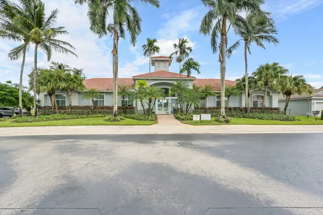 a front view of house with yard fountain and outdoor seating