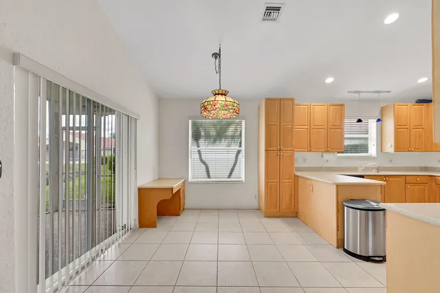a view of a kitchen with a sink and a refrigerator